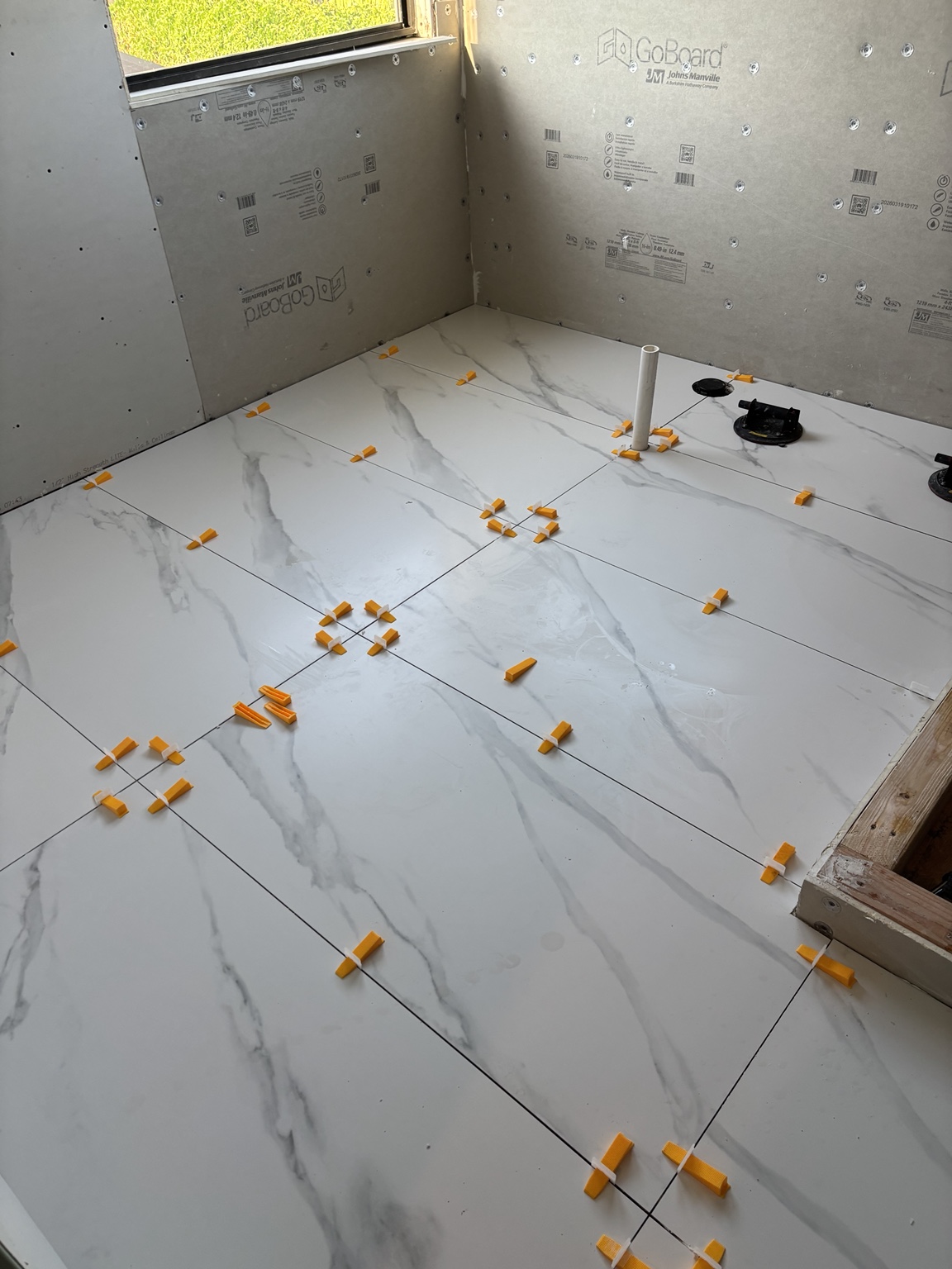 Large-format bathroom tile installation
